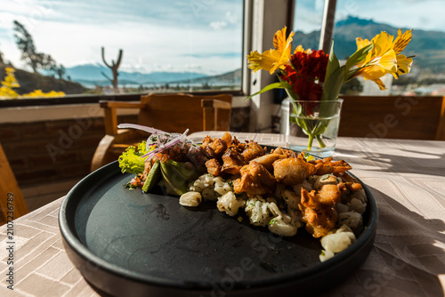 Bild auf Leinwand Gourmet presentation of traditional mote with crispy pork chicharron, avocado, a