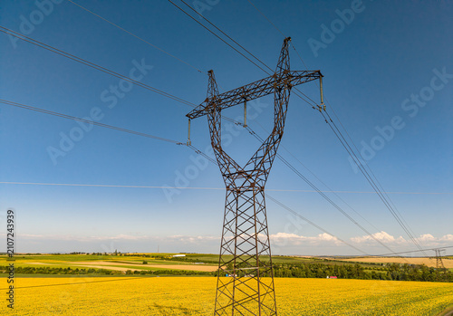 Картината върху платно Metal electricity pylon in agricultural field, high voltage power line transmiss