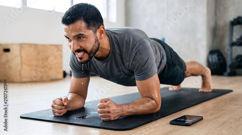 man doing plank exercise sweating hard in gym