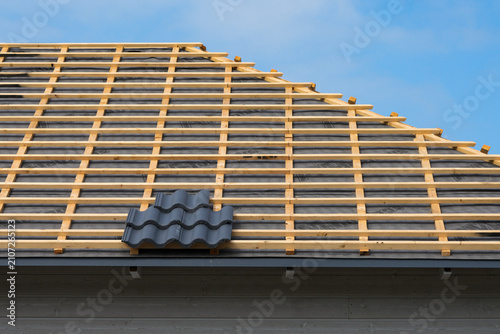 Roof battens and underlayment prepared for roof tile installation on modern timber frame house
