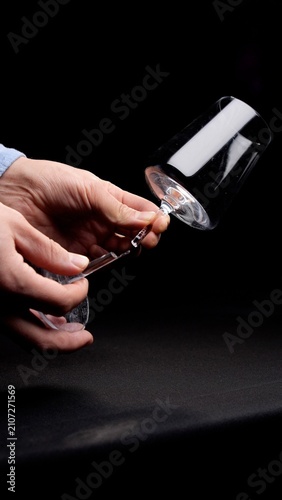 Fotografie Person's hands carefully holding the shattered stem of a delicate wine glass, ob