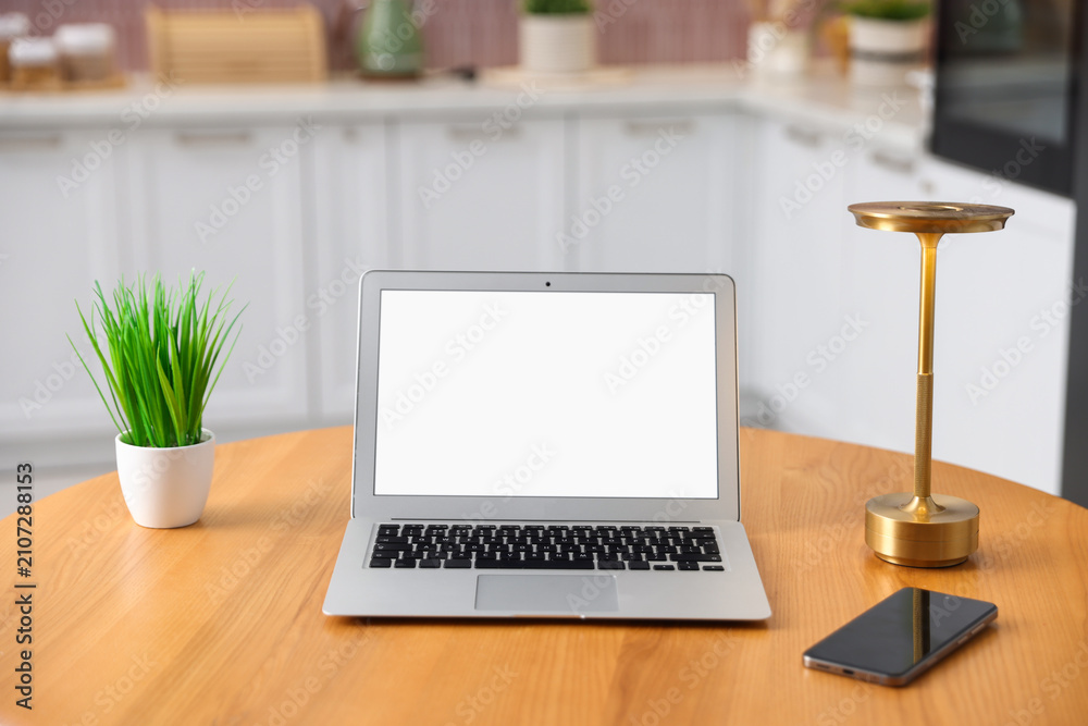 Fototapeta premium Comfortable workplace with laptop on wooden table indoors