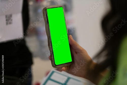 Woman Holding Smartphone with Green Screen Mockup for Mobile App Presentation