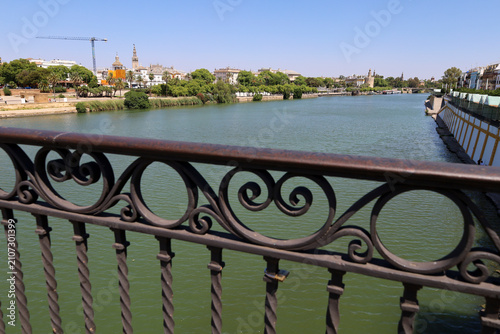 Fotografie The Famous Triana bridge or Isabel II bridge over the Guadalquivir River in Sevi