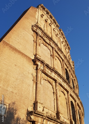 Foto Historic Colosseum Arches Against Blue Sky