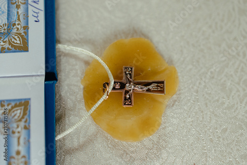 Fotografie Close-up of a baptism cross resting in a person's hand during a Christian baptism ceremony