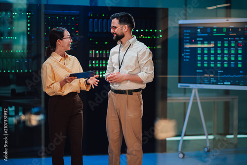 It professionals discussing data center infrastructure and network security in a modern server room