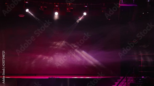The stage of the theater illuminated by spotlights from the auditorium