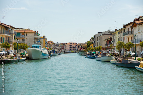 View of Mandracchio fishing harbor Grado Friuli Venezia Giulia Italy colorful houses boats canal
