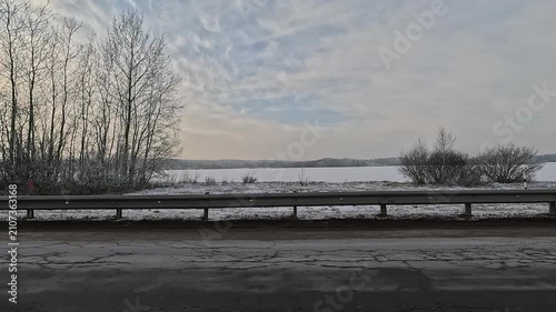 Along the road, on a white snowy winter day. roadside view, view from the car window	