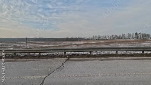 Along the road, on a white snowy winter day. roadside view, view from the car window	