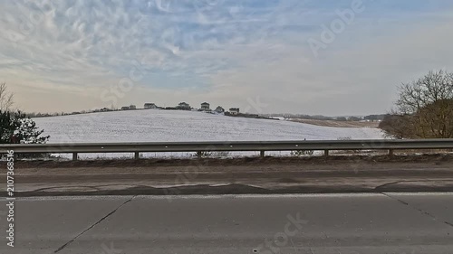 Along the road, on a white snowy winter day. roadside view, view from the car window	