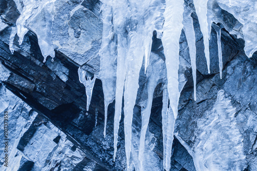Hanging Icicles on Rocky Cliff Surface in Winter — Ice Cave Detail