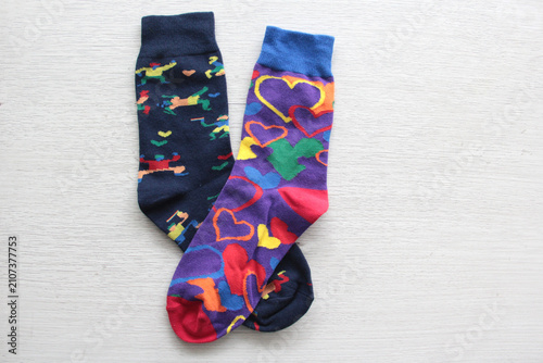 Colorful, mismatched socks ready to be worn as a symbol of inclusion, diversity, and acceptance to promote respect for people with Down syndrome