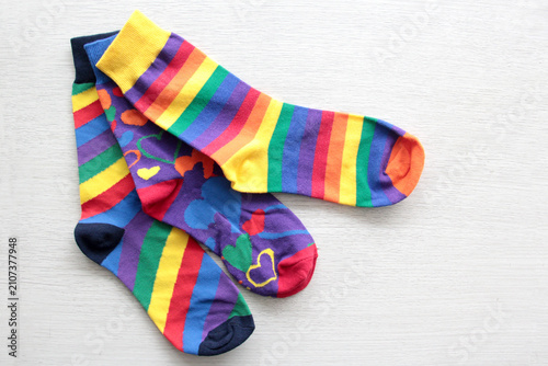 Colorful, mismatched socks ready to be worn as a symbol of inclusion, diversity, and acceptance to promote respect for people with Down syndrome