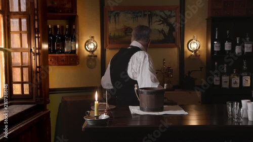 Saloon keeper washing shot glasses