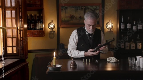 Saloon keeper unloading pistol