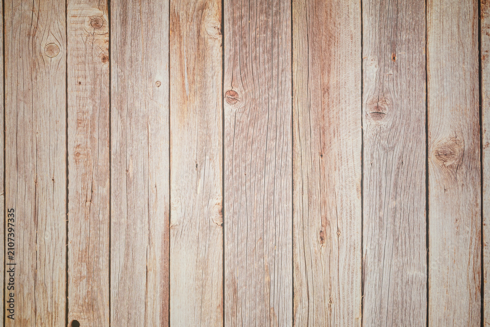 Obraz premium vertical texture of an old fence made of unpainted wooden planks with knots and cracks