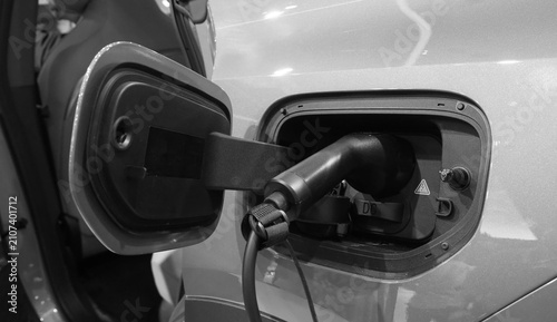 Quadro su tela Electric vehicle charging at a station for modern sustainable transportation and