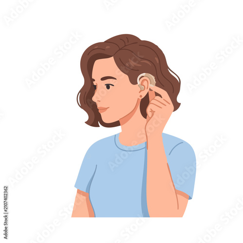 Woman adjusts hearing aid in a simple setting while focused on proper fit and use of device