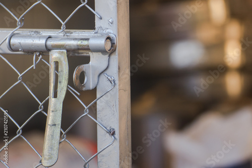 Close up of a rustic wooden door with metal lock