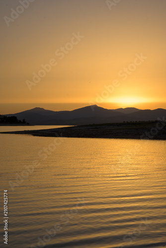 Cuadro en lienzo Golden sunset over mountain reservoir