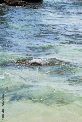 Crystal Clear Tropical Sea Water Flowing Over Rocky Seabed in Shallow Coastal Paradise