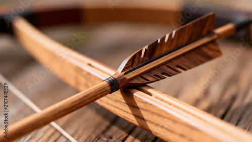 Arrow nock fitted on bowstring, carved groove and wood grain in soft light.