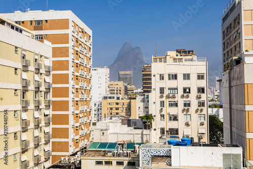 Dense urban architecture of Rio de Janeiro featuring apartment blocks and Dois Irmãos mountain peak