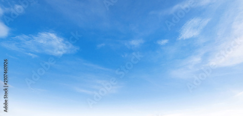 Clear blue sky with wispy clouds above