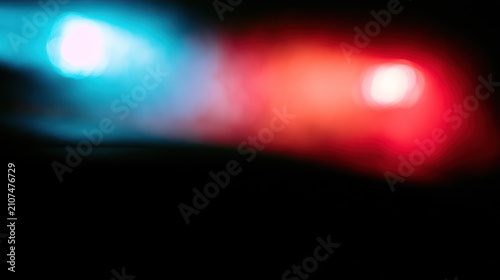 Soft bokeh background of emergency blue and red lights.