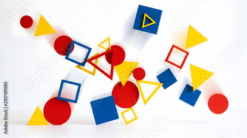 Colorful primary geometric shapes floating in dynamic motion with artistic motion blur effects
