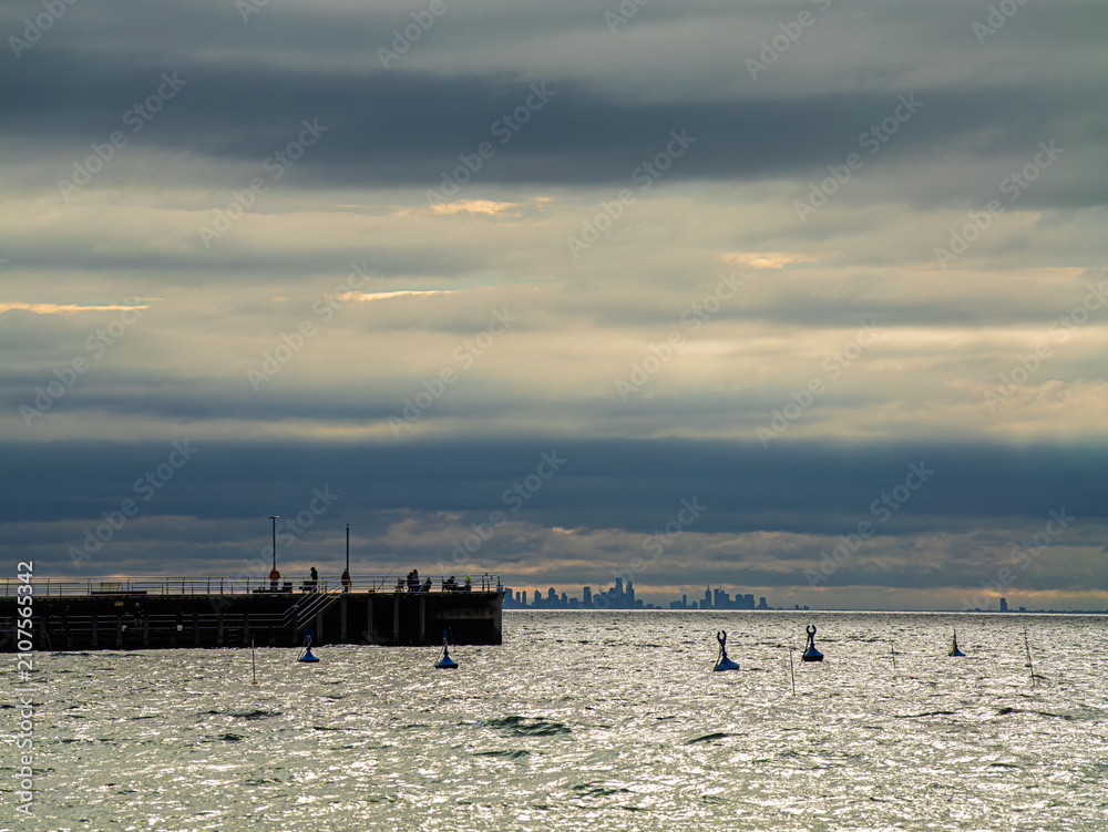 Obraz premium Cold Winter Pier With Distant City Views
