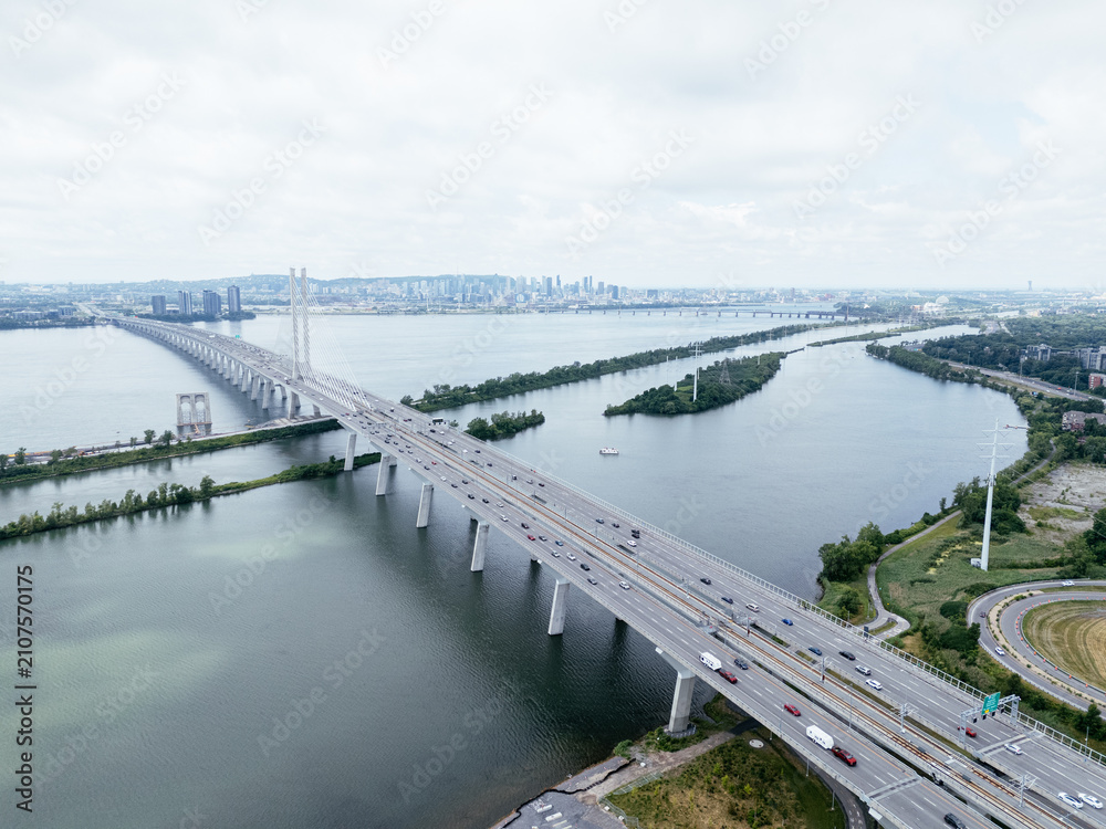 Obraz premium Aerial view of Brossard suburban Montreal skyline beyond the river and bridge. g