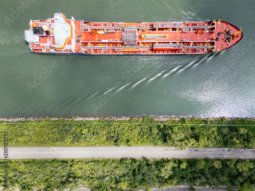 Aerial top view of oil tanker cargo ship navigating the St Lawrence River near Montreal, Canada. g.