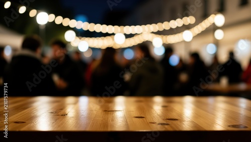 Evening Gathering Under String Lights: A wooden table is in the foreground, with a blurred background of people enjoying a nighttime gathering under a canopy of warm, illuminated string lights.