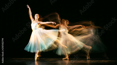 Ballerina in flowing white and blue tutu performing dance moves on stage ballet dancer motion
