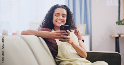 Cuadro en lienzo Cellphone, happy and woman on sofa in home with texting, social media or networking on mobile app