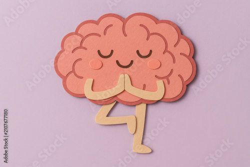 Paper cut brain character meditating in yoga tree pose, hands pressed together, eyes closed, calm expression, promoting mental health and mindfulness on lavender background