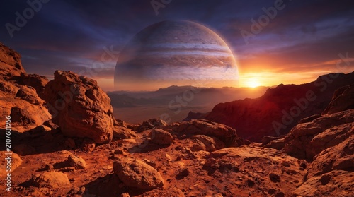 Dramatic alien world landscape at dawn, featuring sharp red rocks and a colossal ringed planet looming in the glowing cosmic sky.