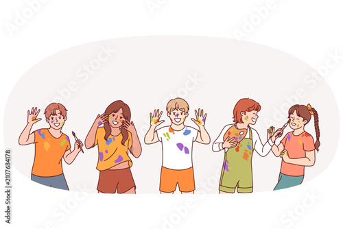 Little artist children with paint stains on hands and clothes rejoice at opportunity to develop creativity. Boys and girls artists from kindergarten laugh after lesson on drawing and creative