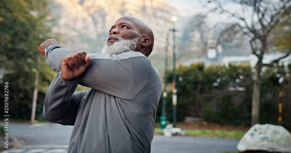Obraz premium Fitness, start or black man outdoor with stretch, arm mobility or injury prevention in retirement activity. Wellness, active or senior person with preparing, shoulder or muscle improvement in warm up