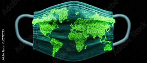Protective face mask with green glowing world map print isolated on black background conceptual design representing global health pandemic