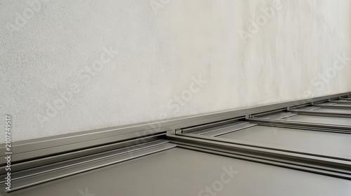 Modern sliding door metal floor tracks against concrete wall 3D render
