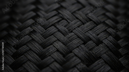 Intricate dark braided texture forming a detailed interwoven pattern, showcasing robust strength and elegant design in a close-up view suitable for various backgrounds and graphic applications