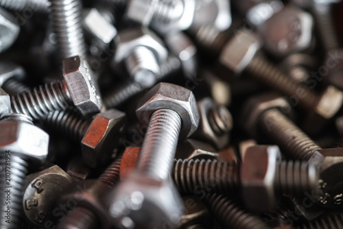 Close Up Steel Nuts and Bolts with Metal Screws and Threaded Industrial Fasteners Isolated on White Background
