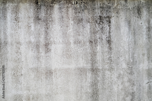 black mold indicating damp on outside white cement wall.