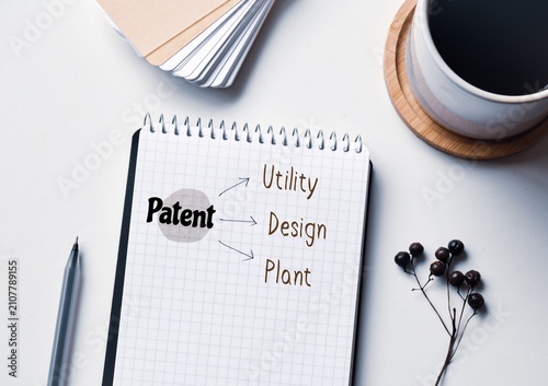 Fotografía Three types of patent, the Government issued legal document about inventions written on notepad on office desk background