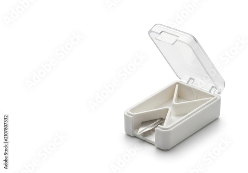 White plastic pill cutter or splitter box isolated on a clean white background.