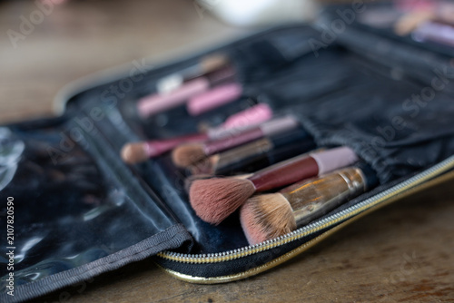 Cuadro en lienzo Makeup brush set in black roll up pouch with soft bristles and metal ferrule on